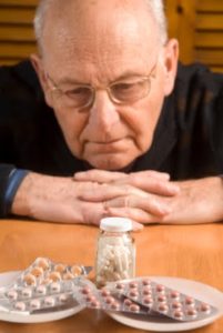 Old man eating pills