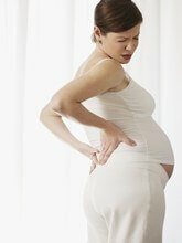Aching ländryggen under graviditetsfoto