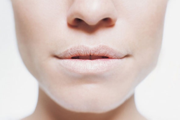 Why does the pallor of the lips appear in children and adults?