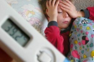 Ein krankes Kind mit einem Thermometer mit hoher Temperatur